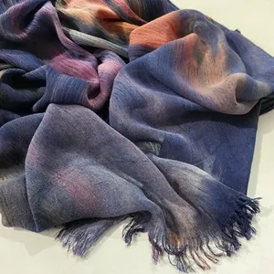 Close-up detail of a vintage ethnic style gradient pleated long scarf with natural fringed edges
