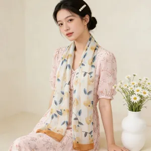 Elegant French floral georgette silk scarf styled as a thin neck wrap on a female model