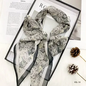 Close-up of cold-toned Paisley chiffon skinny scarf with hand-rolled edges for women