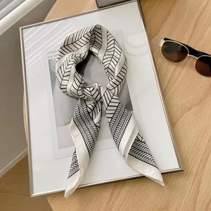 Detailed view of a 70cm silk scarf with black and white herringbone geometric pattern