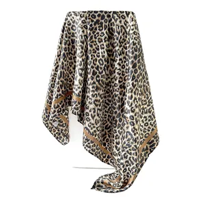 Close-up detail showing the smooth and glossy satin texture of a brown leopard print square scarf