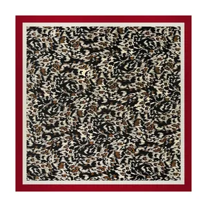 Full view of a leopard print satin silk square scarf featuring a bold red border design