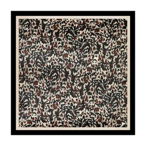 Close-up detail of square leopard print satin scarf showing the rich pattern texture