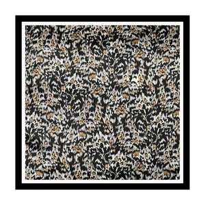 Close-up detail showing the intricate classic leopard print on a smooth satin scarf