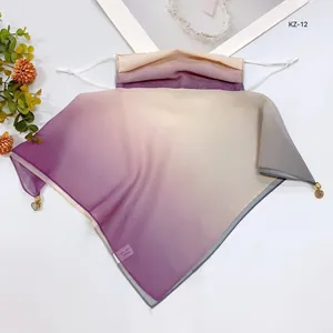 Detail of gradient silk face mask scarf with UV protection and breathable fabric.