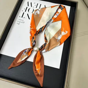 Elegant orange horse print skinny silk scarf with a pearl magnetic buckle closure