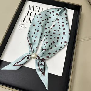 Elegant light blue neck scarf with brown polka dots and a magnetic pearl buckle detail