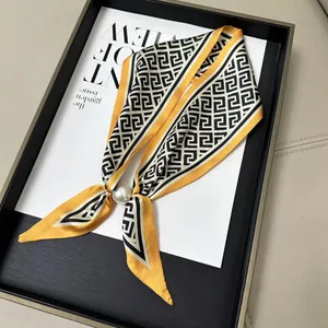 Elegant yellow silk scarf with geometric maze pattern and large pearl magnetic clasp