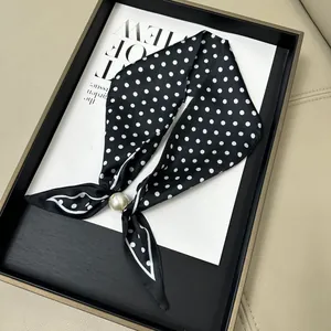 Elegant black and white polka dot neck scarf featuring a decorative white pearl bead