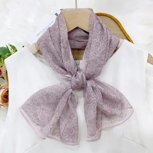 Elegant lavender floral print chiffon ribbon scarf styled on a white sleeveless top