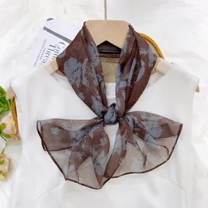 Floral pattern chiffon ribbon scarf styled on an elegant white dress for daily wear