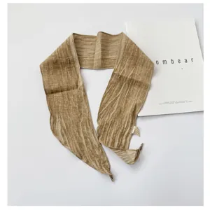 Natural texture of a lightweight ramie long scarf in earth tone, minimalist style