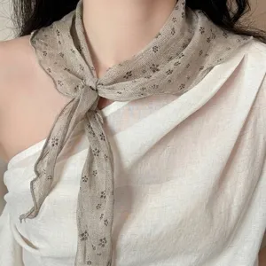 Close-up detail of 100% linen floral print scarf tied as a necktie in retro Japanese style.