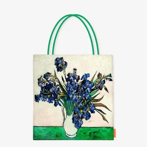 Artistic canvas tote bag featuring Van Gogh's Irises oil painting with green handles
