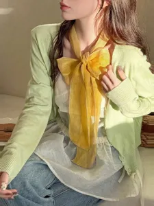 Retro yellow 100% linen scarf styled as a large decorative bow tie for women