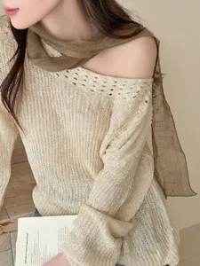 Close-up of a brown thin gauze scarf styled with a cream crochet knit sweater top