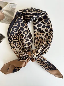 Vista dettagliata di un foulard in seta leopardato annodato in un nodo decorativo chic
