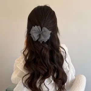 Elegant Korean style gingham bow hair clip shown in a half-up hairstyle back view.