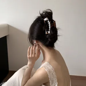 Close-up of a stylish leopard print hair claw clip for a sophisticated bun hairstyle