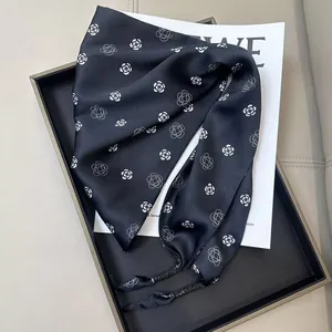 Elegant black triangle silk scarf featuring white camellia flower patterns for women