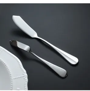 Pair of mirror-polished stainless steel butter knives featuring phoenix tail handles