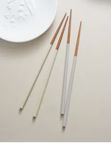 Macro view of Japanese style octagonal wood chopsticks with textured non-slip handles.