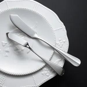 Professional stainless steel butter knife set with mirror finish on white plate