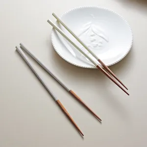 Elegant Japanese octagonal anti-slip ironwood chopsticks on a white ceramic plate.