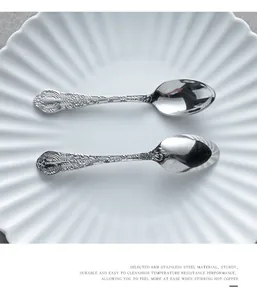 Close-up detail of ornate embossed jasmine flower pattern on 18/8 stainless steel spoon