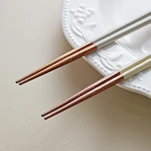 High-quality Japanese style pointed octagonal ironwood chopsticks on ceramic plate