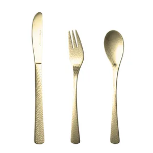 Elegant gold hammered stainless steel cutlery set with knife fork and spoon on white back