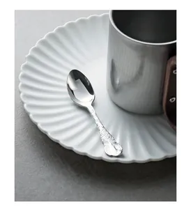 Close-up of embossed jasmine patterns on a vintage mirror silver stainless steel spoon