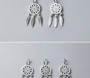 Detailed macro view of S925 sterling silver dreamcatcher pendants with feather tassels
