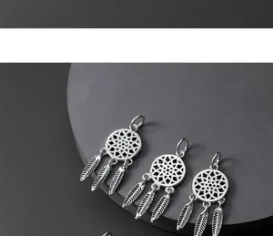 Detailed view of three S925 sterling silver dreamcatcher pendants with tassel feathers.