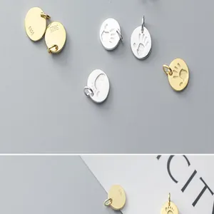 Close-up detail of S925 sterling silver palm and footprint pendants with gold plating for DIY jewelry