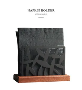 Modern Nordic minimalist napkin holder with wooden base and black metal cutout frame