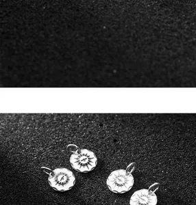Macro detail of engraved bird pattern on 11mm vintage S925 silver round pendant tags