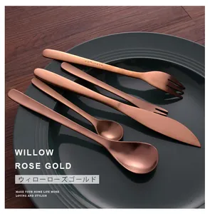 High-quality retro rose gold willow leaf cutlery set elegantly arranged on a dark green plate