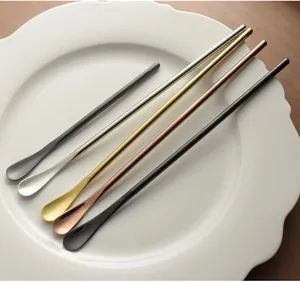 Set of five colorful long-handled 304 stainless steel stirring spoons on a white plate