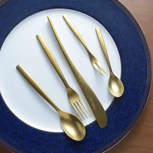 Vintage style luxury gold stainless steel cutlery set including knife and spoon on plate