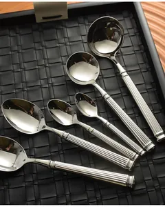 Detailed macro view of polished 304 stainless steel spoons with Roman column handles
