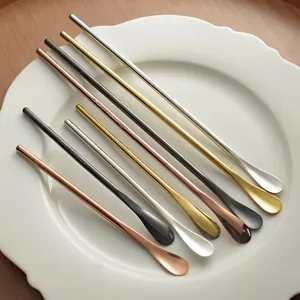 Multi-colored 304 stainless steel long handle coffee stirring spoons on white ceramic plate