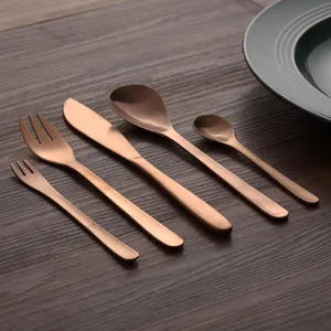 Elegant 5-piece vintage rose gold 304 stainless steel cutlery set on a wooden table