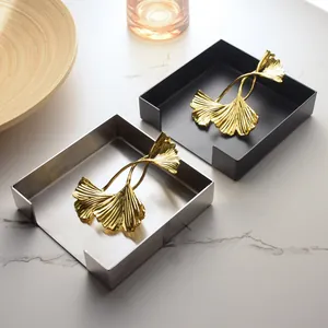 Modern stainless steel square napkin holder with decorative gold ginkgo leaf weight