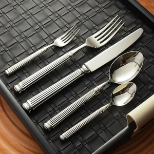 Elegant 304 stainless steel cutlery set with Roman column handles on a black tray