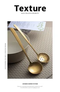Detail of Japanese hammer pattern gold stainless steel soup ladle and skimmer spoon.