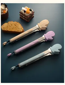 Detailed view of three cute silicone mitt-shaped food tongs in pastel colors on blue background