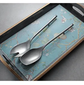 Detail view of 304 stainless steel serving spoons with matte finish in a tray