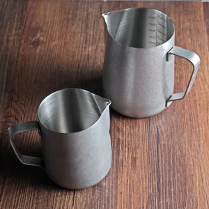 Pair of stainless steel milk frothing pitchers with precise internal scales for latte art