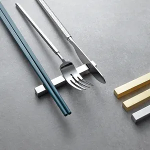Minimalist 304 stainless steel cutlery rest for knives, forks and chopsticks on grey stone